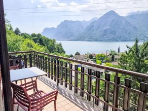 a balcony with a table and chairs and a view of a lake at Apartment Villa Martinelli-1 by Interhome in Crone