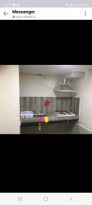 a picture of a kitchen with a sink and a stove at mianino in Itʼkhvisi