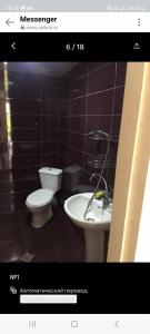 a bathroom with a toilet and a bidet and a sink at mianino in Itʼkhvisi