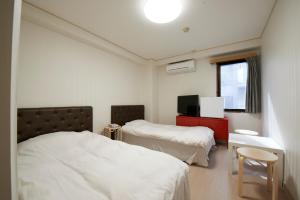 Postel nebo postele na pokoji v ubytování Hotel Empire in Shinjuku