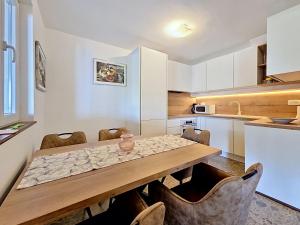 a kitchen with a wooden table and some chairs at Holiday Home Peter by Interhome in Prigradica