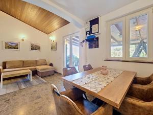 a living room with a wooden table and chairs at Holiday Home Peter by Interhome in Prigradica