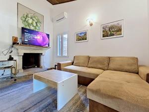 a living room with a couch and a fireplace at Holiday Home Peter by Interhome in Prigradica