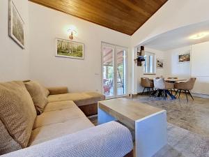a living room with a couch and a table at Holiday Home Peter by Interhome in Prigradica +13 photos