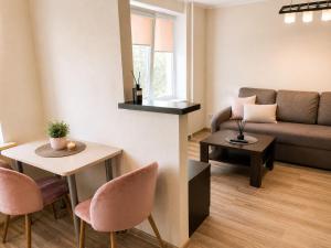 a living room with a couch and a table at Nemunas in Panevėžys