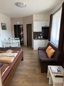 a living room with a couch and a kitchen at Apartmány Polevsko in Polevsko