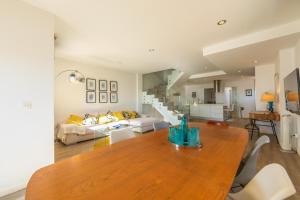 a living room with a table and a couch at Caracolas Luxury House Duplex in Tarifa