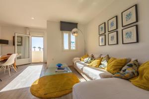 a living room with a couch and a table at Caracolas Luxury House Duplex in Tarifa