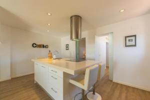 a kitchen with white cabinets and a counter top at Caracolas Luxury House Duplex in Tarifa +41 photos