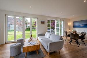 a living room with a couch and a table at Traumgarten Villa Harmonie in Prerow