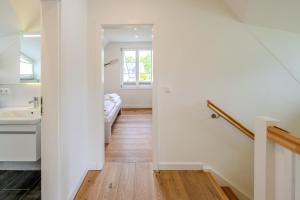 a white bathroom with a sink and a toilet at Traumgarten Villa Harmonie in Prerow +30 photos