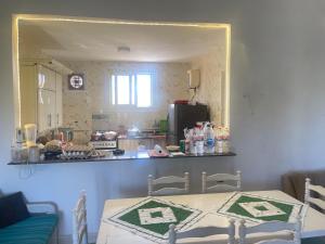 a kitchen with a table in front of a mirror at chalet ramsis village in Alexandria