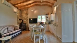 a kitchen and living room with a table and a couch at Villa Skala by Villas Guide in Novi Vinodolski