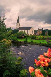 a church and a river in front of a church at Brodie Cottage in Killin +7 photos