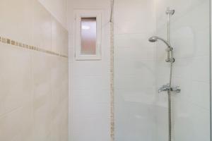 a bathroom with a shower with a glass door at Limbarto - Gîte climatisé au calme in Serra-di-Ferro +24 photos