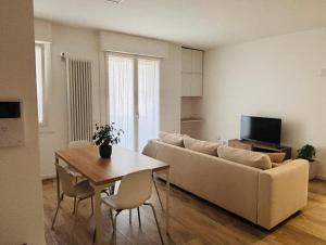 a living room with a couch and a table at Bassano Sweet Home in Bassano del Grappa