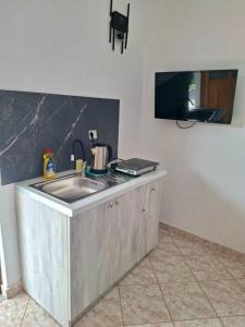a kitchen with a sink and a counter top at Dimora Seaside Apartments in Ksamil +29 photos