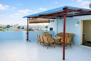 a patio with a table and chairs on a roof at Sri Apartment Homestay 2BHK Pondicherry A2 in Pondicherry