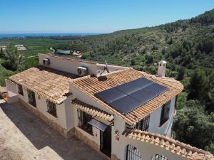 a house with a solar panel on the roof at Holiday Home Del Azahar by Interhome in Monte Pego