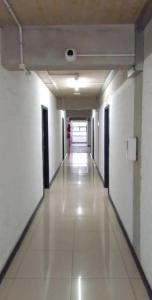 a hallway with white walls and a long hallway with white floors at Heavens stay in Vosburg