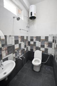 a bathroom with a toilet and a sink at Sri Apartment Homestay 2BHK Pondicherry A2 in Pondicherry