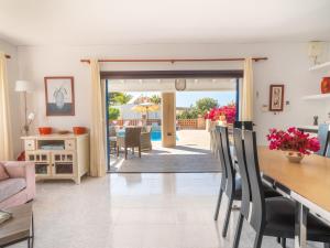 a living room with a table and a dining room at Holiday Home Anromi by Interhome in Cala Vadella