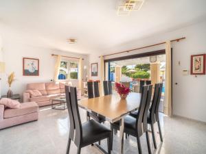 a dining room with a table and chairs at Holiday Home Anromi by Interhome in Cala Vadella
