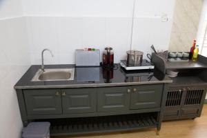 a kitchen with a sink and a counter top at New Sala Homestay in Hue