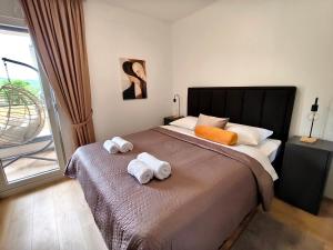 a bedroom with a large bed with towels on it at Nota in Veliko Gradište