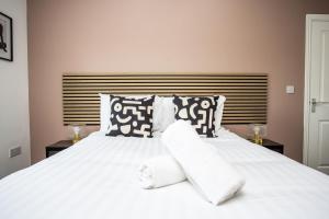 a bedroom with a white bed with two pillows at Arkless Grove FREE Parking WiFi in Black Hill