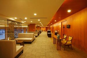 a waiting room with couches and chairs and tables at Centara Udon in Udon Thani