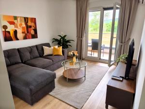 a living room with a couch and a glass table at Nota in Veliko Gradište
