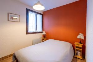 a bedroom with a white bed and a window at Central Parc T2 Pour 4 Pers in Briançon