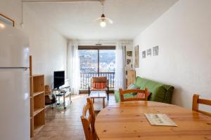 a kitchen and living room with a wooden table at Central Parc T2 Pour 4 Pers in Briançon +12 photos
