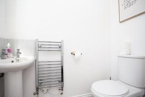a white bathroom with a toilet and a sink at Arkless Grove FREE Parking WiFi in Black Hill +28 photos