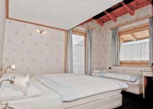 a bedroom with two beds and a window at La Locanda in Livigno