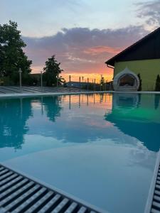 a pool of water with a sunset in the background at Hotel Wurzer in Tännesberg