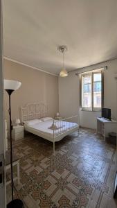 a bedroom with a bed and a rug at Sunset hostel Palermo in Palermo