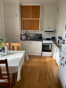 a small kitchen with a table and a refrigerator at 5ans rum in Skellefteå