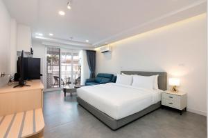 a hotel room with a bed and a television at Mac's House in Bangkok