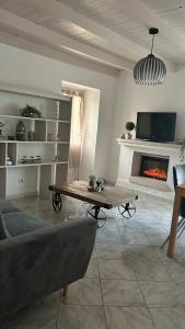 a living room with a couch and a fireplace at Casa Ghjuvanna 2 chambres in Prunelli-di-Fiumorbo +5 photos