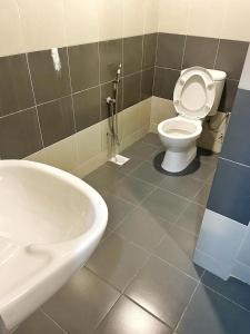 a bathroom with a toilet and a sink at V Cozy Homestays in Brinchang +32 photos