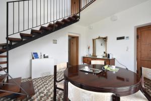 a dining room with a table and a staircase at Monti d'Abruzzo in Crecchio