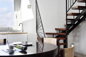 a dining room with a table and chairs and a staircase at Monti d'Abruzzo in Crecchio
