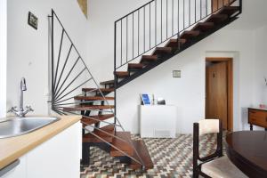 a kitchen with a sink and a staircase at Monti d'Abruzzo in Crecchio