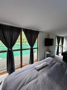 a bedroom with a bed and a large window at Pablo's place in Rezine +46 photos