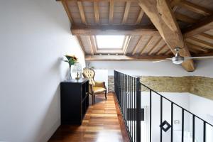a hallway with a staircase with a chair and a ceiling at Monti d'Abruzzo in Crecchio