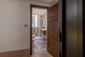 an open door to a bathroom with a toilet at Palazzo Brighenti in Pozzolengo +52 photos