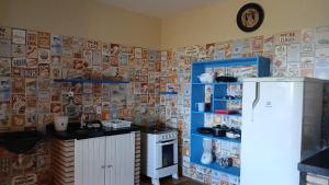 a kitchen with a stove and a refrigerator at Flat Casa Taiba 2001 in Taíba