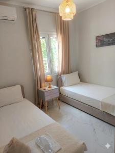 a small bedroom with two beds and a table at Electra Gaios Apartment in Gaios